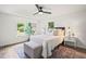 Bright bedroom featuring wood floors, stylish décor, a ceiling fan, and a picturesque window view at 1621 N Park Ave, Burlington, NC 27217