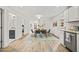 Bright dining area with a modern table set and hardwood-style flooring adjacent to the kitchen at 1621 N Park Ave, Burlington, NC 27217