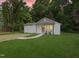 Charming home featuring a manicured lawn, concrete walkway and inviting front porch seating at 1621 N Park Ave, Burlington, NC 27217