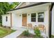 Charming front porch with seating, natural wood beams and fresh landscaping at 1621 N Park Ave, Burlington, NC 27217