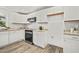 Modern kitchen featuring granite countertops, stainless steel appliances, and white cabinets at 1621 N Park Ave, Burlington, NC 27217