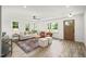 Open-concept living room with a cozy seating area and a beautifully stained front door at 1621 N Park Ave, Burlington, NC 27217