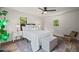 Comfortable bedroom with wood flooring, ceiling fan, and natural light from two windows at 1621 N Park Ave, Burlington, NC 27217