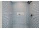 Modern shower with blue subway tile and niche storage for bath supplies at 1621 N Park Ave, Burlington, NC 27217