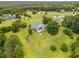 Idyllic aerial shot of the property, highlighting the sprawling fenced yard and surrounding trees at 1672 Wheeler Dr, Angier, NC 27501