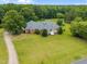 Aerial shot of a beautiful home situated on a sprawling green lot with mature trees at 1672 Wheeler Dr, Angier, NC 27501