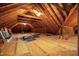 Unfinished attic space with exposed wooden beams and plywood flooring at 1672 Wheeler Dr, Angier, NC 27501