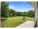 Large backyard with lush greenery and a playground at 1672 Wheeler Dr, Angier, NC 27501
