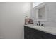 Bathroom with a granite countertop, a dark cabinet, a large square mirror, and modern finishes at 1672 Wheeler Dr, Angier, NC 27501