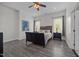 This bedroom offers a sleek platform bed, two bedside tables with lamps, and stylish gray vinyl flooring at 1672 Wheeler Dr, Angier, NC 27501