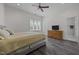 Well-lit bedroom features vinyl floors, a dresser, and a comfortable bed next to a window at 1672 Wheeler Dr, Angier, NC 27501