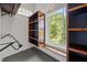 Functional closet with open shelving, clothes rods, and a window with outdoor views at 1672 Wheeler Dr, Angier, NC 27501