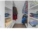 Organized walk-in closet offering ample storage with shelving and hanging rods for clothing and linens at 1672 Wheeler Dr, Angier, NC 27501