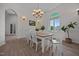 Elegant dining room featuring a wood table, designer lighting, and ample natural light at 1672 Wheeler Dr, Angier, NC 27501