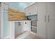 Custom dog wash station with white subway tile, wood accents, and storage cabinets at 1672 Wheeler Dr, Angier, NC 27501