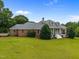 Beautiful home with well-manicured lawn and mature trees at 1672 Wheeler Dr, Angier, NC 27501