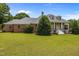 Charming home exterior with a well-manicured lawn and a welcoming front porch at 1672 Wheeler Dr, Angier, NC 27501