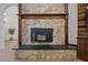Close up view of an indoor fireplace with unique stone work and wooden mantel at 1672 Wheeler Dr, Angier, NC 27501