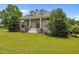 Inviting home boasting a well-manicured lawn, beautiful architectural design, and classic facade at 1672 Wheeler Dr, Angier, NC 27501