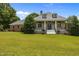 Charming home featuring a well-manicured front yard, classic architectural design and inviting entryway at 1672 Wheeler Dr, Angier, NC 27501