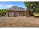 Brick garage with three bays and an expansive gravel driveway at 1672 Wheeler Dr, Angier, NC 27501