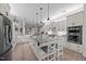 Spacious kitchen featuring a large island, white cabinetry, and modern stainless steel appliances at 1672 Wheeler Dr, Angier, NC 27501