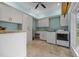 Bright laundry room with ample white cabinetry, butcher block counters and stainless steel appliances at 1672 Wheeler Dr, Angier, NC 27501