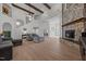Open-concept living room with vaulted ceilings, stone fireplace, and beautiful flooring at 1672 Wheeler Dr, Angier, NC 27501
