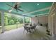 Covered porch with ceiling fans, ample seating and beautiful backyard view at 1672 Wheeler Dr, Angier, NC 27501