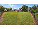 Large yard with a green lawn and chain link fence surrounding the property at 1672 Wheeler Dr, Angier, NC 27501