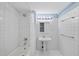 Bright bathroom featuring a tiled shower and single sink at 1705 Nottingham Rd, Raleigh, NC 27607