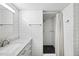 Bright bathroom featuring a tiled shower, dual shower heads, and single sink at 1705 Nottingham Rd, Raleigh, NC 27607