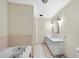 Traditional bathroom features a bathtub, vanity, and hexagon tile flooring at 1705 Nottingham Rd, Raleigh, NC 27607
