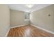 Bright bedroom with a window and hardwood floors at 1705 Nottingham Rd, Raleigh, NC 27607