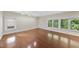 Bright bedroom with wood floors and large windows offering natural light at 1705 Nottingham Rd, Raleigh, NC 27607