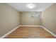 Bright bedroom with neutral walls, hardwood floors, and a window letting in natural light at 1705 Nottingham Rd, Raleigh, NC 27607