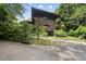 Beautiful brick home with a unique architectural design featuring mature landscaping and a winding driveway at 1705 Nottingham Rd, Raleigh, NC 27607