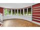Bright living room featuring a curved window wall with built-in storage and hardwood floors at 1705 Nottingham Rd, Raleigh, NC 27607