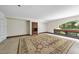 A spacious living area, bathed in natural light and adorned with a beautiful area rug at 1705 Nottingham Rd, Raleigh, NC 27607