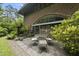Brick home featuring an outdoor patio with stone pavers, an arched window and outdoor seating at 1705 Nottingham Rd, Raleigh, NC 27607