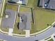 Aerial view of a single-Gathering home featuring a landscaped yard, a patio, and a concrete driveway at 1727 Pinecliff Ct, Fuquay Varina, NC 27526