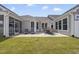 Backyard with a patio and furniture and adjacent screened porch on a sunny day at 1727 Pinecliff Ct, Fuquay Varina, NC 27526