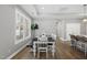 Bright dining area featuring modern furnishings and a large window, perfect for enjoying meals with Gathering at 1727 Pinecliff Ct, Fuquay Varina, NC 27526
