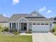 Charming single-story home featuring a two-car garage, manicured lawn, and a welcoming entrance at 1727 Pinecliff Ct, Fuquay Varina, NC 27526