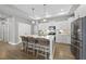 Modern kitchen with a large center island, stainless steel appliances, and elegant pendant lighting at 1727 Pinecliff Ct, Fuquay Varina, NC 27526