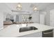Open-concept kitchen featuring a large island, stainless steel sink, and pendant lighting at 1727 Pinecliff Ct, Fuquay Varina, NC 27526