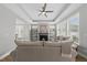 Bright living room with a fireplace, tray ceiling, and large windows offering plenty of natural light and space at 1727 Pinecliff Ct, Fuquay Varina, NC 27526