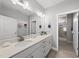 Bathroom featuring double sinks, quartz countertops, and tiled floors at 1727 Pinecliff Ct, Fuquay Varina, NC 27526