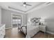 Main bedroom features a tray ceiling, ceiling fan, and access to a balcony at 1727 Pinecliff Ct, Fuquay Varina, NC 27526