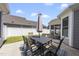 Back patio with an umbrella-covered table and chairs, perfect for outdoor dining and entertaining at 1727 Pinecliff Ct, Fuquay Varina, NC 27526
